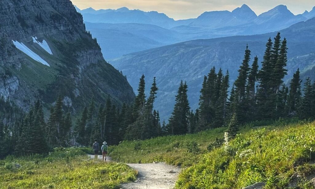 Mountain hiking trail winding through an alpine landscape, symbolizing mindfulness, personal growth, and discovering life's greatest treasures through nature.